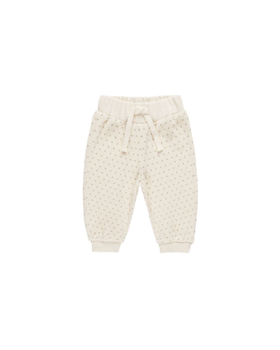 beige velour joggers with gray polka dots on it . drawstring at the waist. 