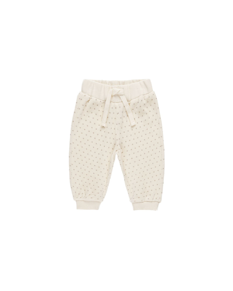 beige velour joggers with gray polka dots on it . drawstring at the waist. 