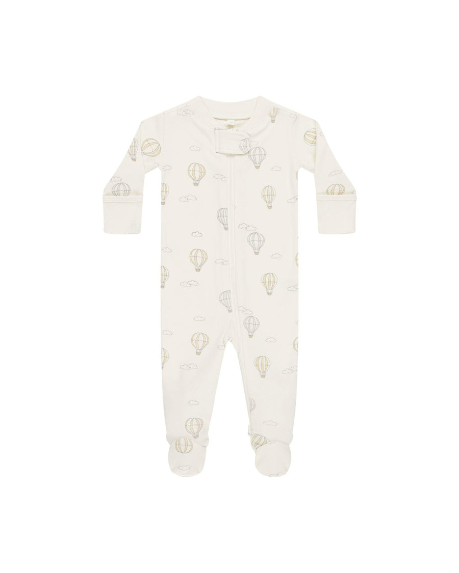beige zipper footie with hot air balloons in pastel colors printed all over it. 