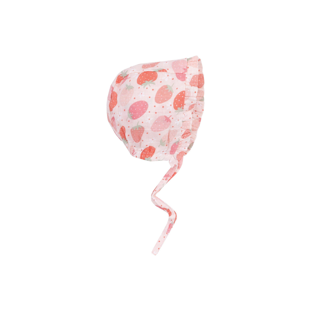 pink baby bonnet with ruffle arounds the efge and red and pink strawberries all over. 
