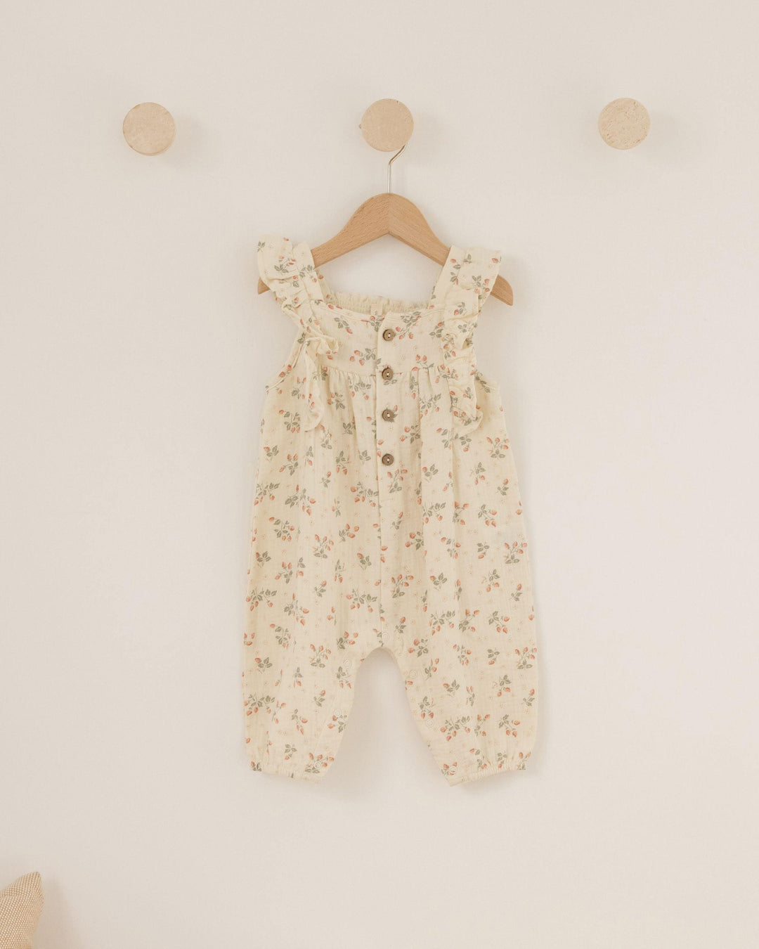 baby girl romper. beige with 4 coconut buttons at the top and flutter sleeves. pants jumpsuit with tiny strawberries 
