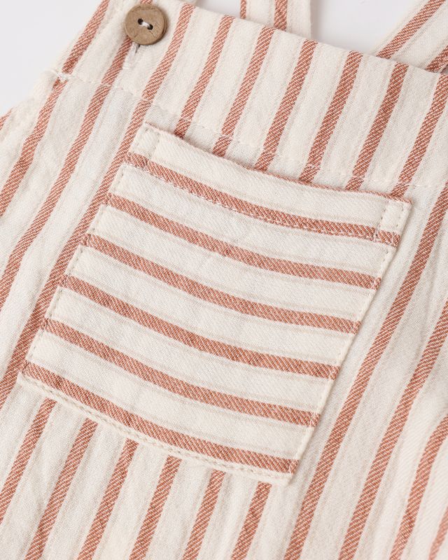 Close-up of a striped fabric with a pocket and button, featuring red and white horizontal lines.