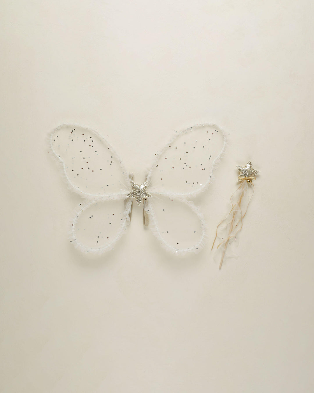 butterfly wings with sheer fabric and a confetti mixed into the wings. a star center in the middle of the wings. 