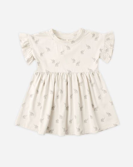 Beige dress with subtle elephant pattern on a white background