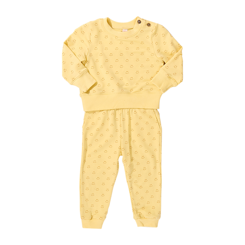 Yellow smiley baby outfit with long-sleeve top and pants on a white background