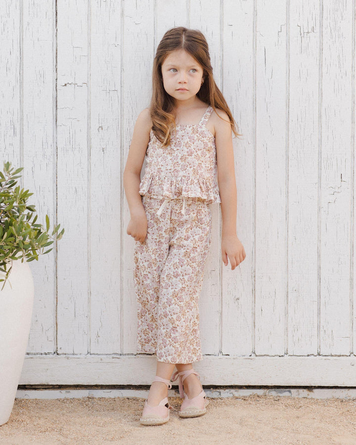 young girl modeling the wildflower pant set, the pants hit above the ankle and the top comes to below her waistline. 
