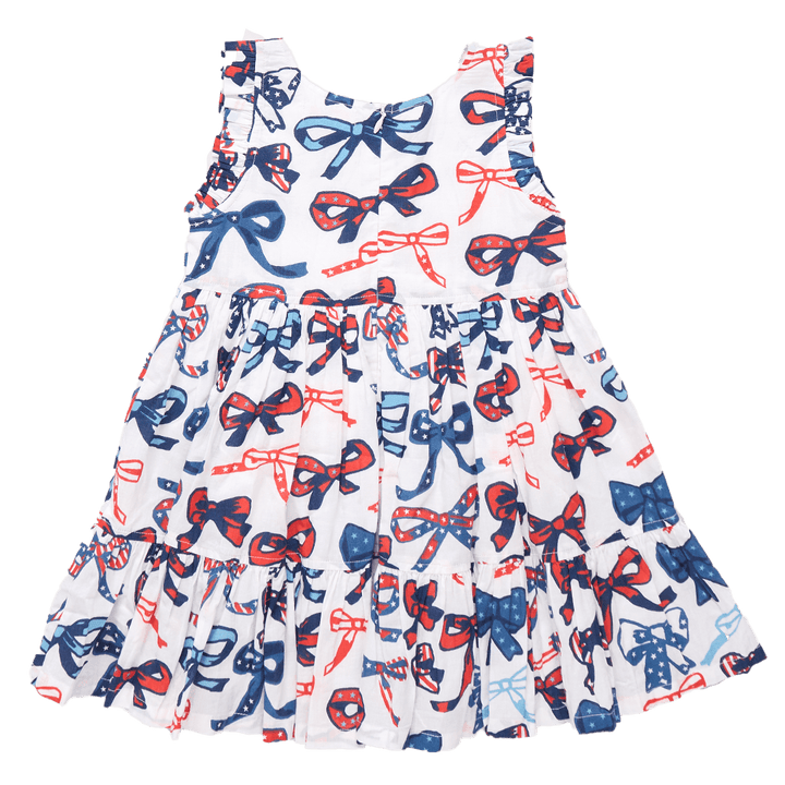 back of dress with hidden zipper and tiered ruffles. sleeveless dress with bows that has red, white and blue stripes and stars in the bows. 