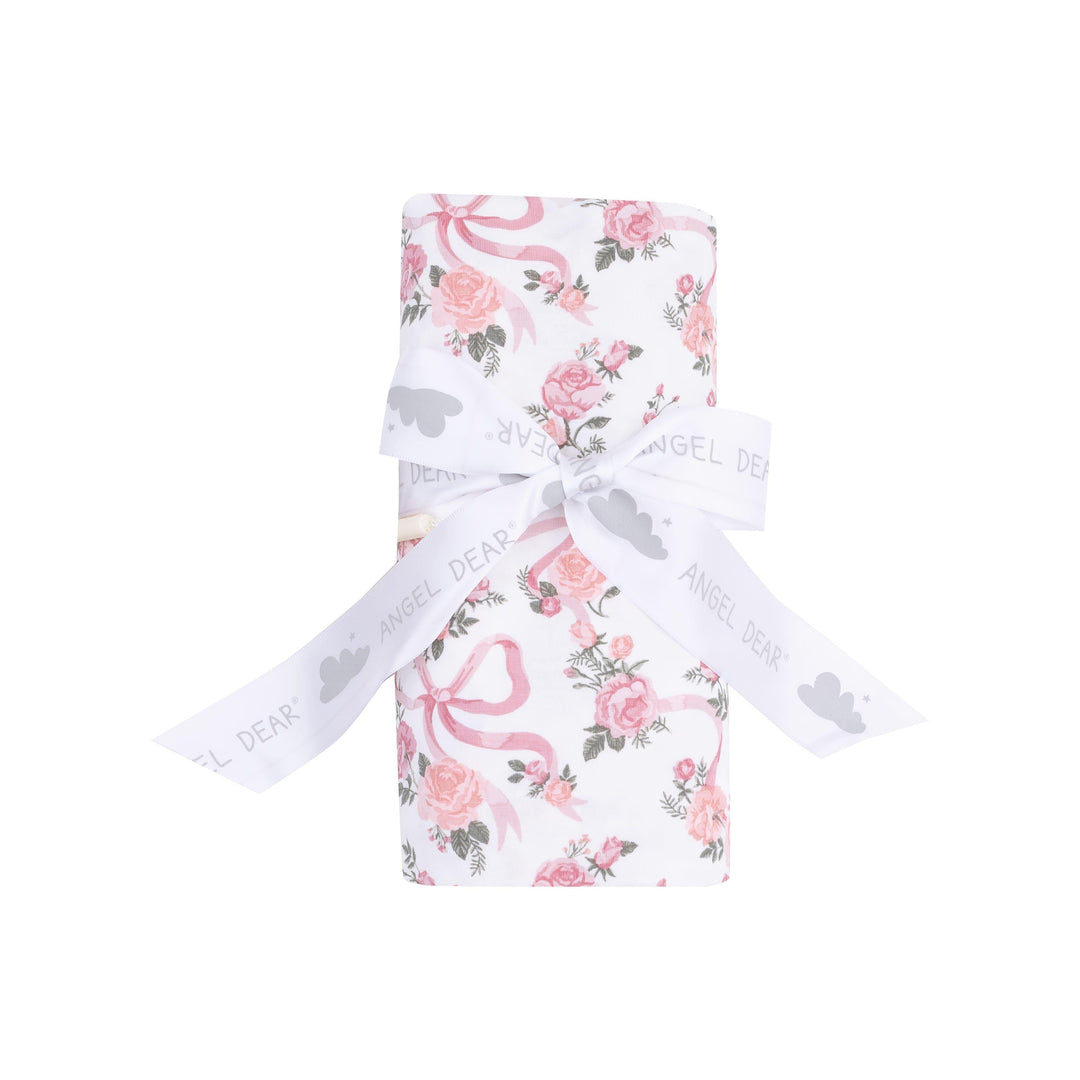 ribbons and flowers swaddle rolled and tied with a bow. this is how the swaddle is packaged and sold. 