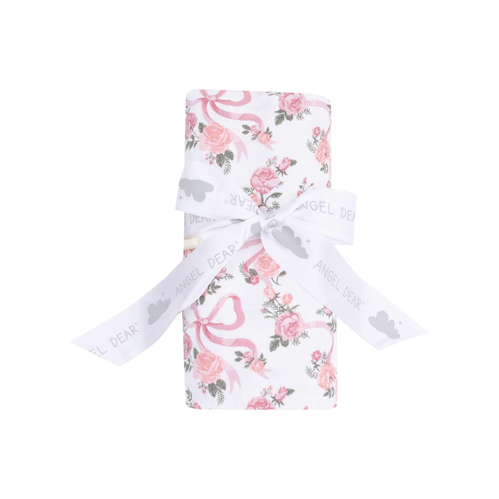 ribbons and flowers swaddle rolled and tied with a bow. this is how the swaddle is packaged and sold. 