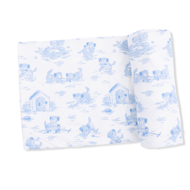 White blanket with blue puppy pattern on a white background