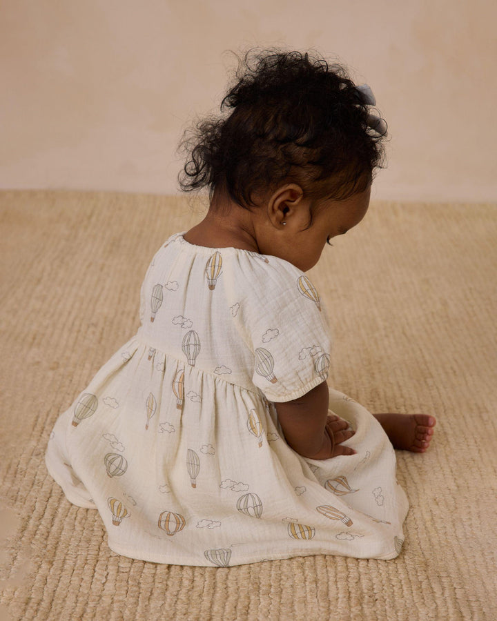 another angle for the baby wearing this dress. you can see the hot air balloon design better from this angle. all different color hot air balloons. 