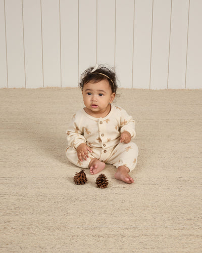 baby wearing gingerbread men jumpsuit. long sleeve and full length pants. 