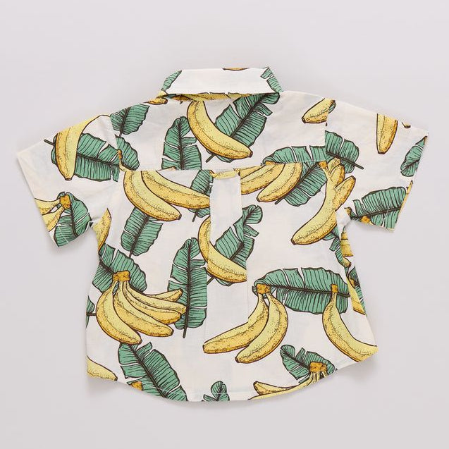 Short-sleeve shirt with banana and leaf pattern on a light gray background