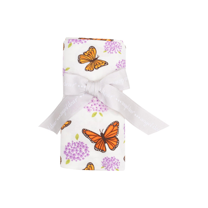 baby swaddle with monarch butterflies and purple milkweed flowers printed on it. this is rolled and tied with a ribbon - it is how it comes from the vendor and sold. 