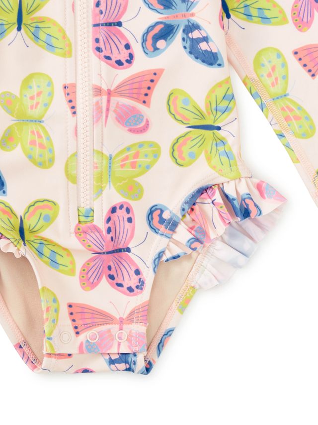 Close-up of a children's swimsuit with colorful butterfly pattern on a white background