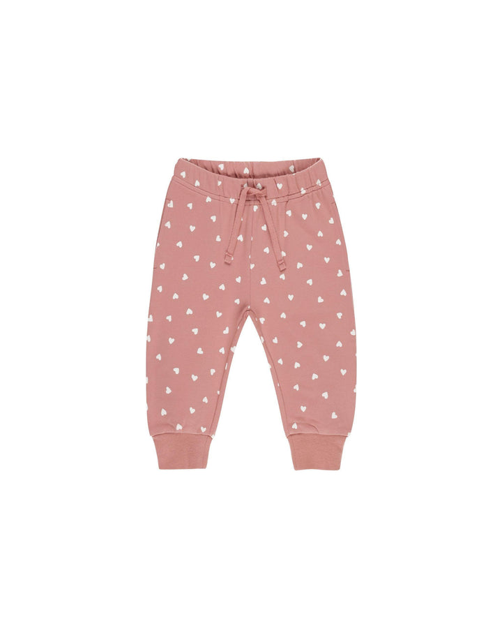 pink joggers with drawstring and tiny white hearts all over it. 