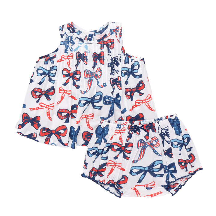 two piece baby outfit with blouse and bloomer, the blouse has a white round with bows that have a patriotic print in them: red, white and blue stripes and stars. 