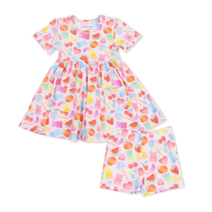 Colorful heart-patterned dress and pants set on a white background