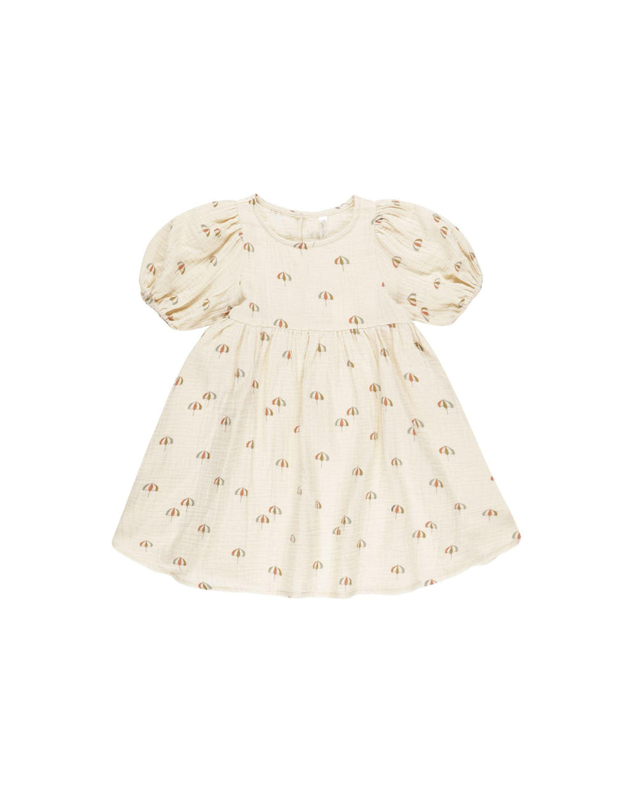 beige dress with puff sleeves and small umbrellas printed all over it. 