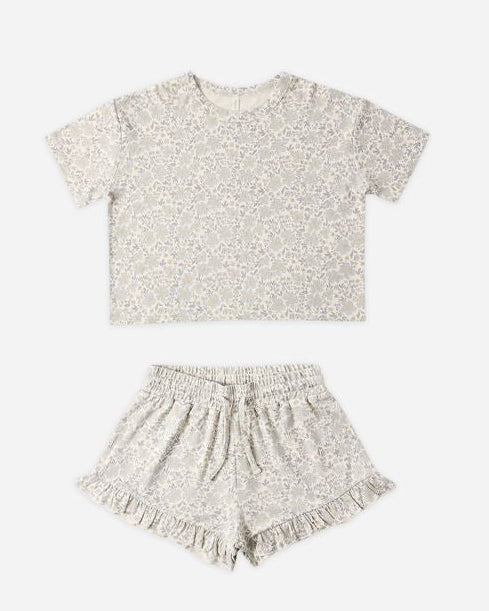 Children's outfit with floral t-shirt and shorts on a white background