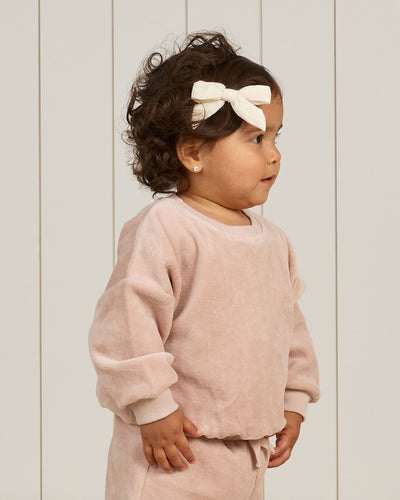 baby girl modeling blush velour sweatset