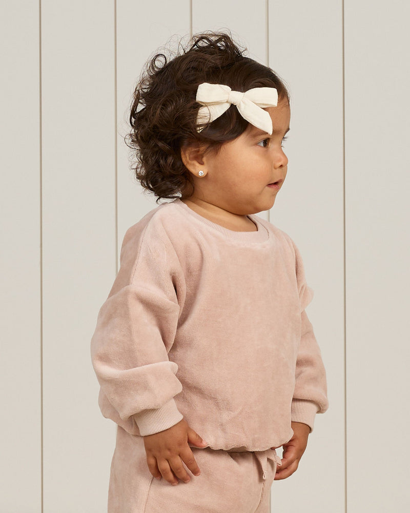 baby girl modeling blush velour sweatset