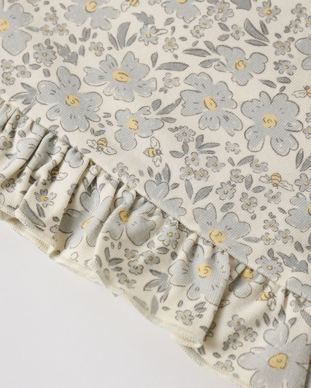 Floral patterned fabric with ruffled edge on a light background