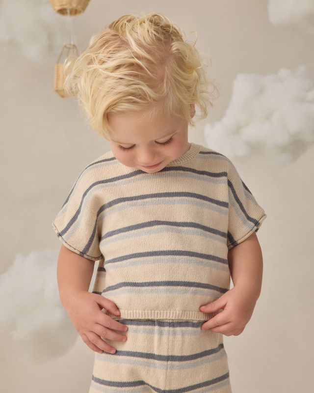 young boy wearing a knit striped outfit 