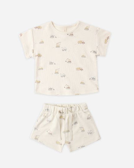 Children's outfit with a cream-colored top and shorts featuring a subtle truck pattern on a white background