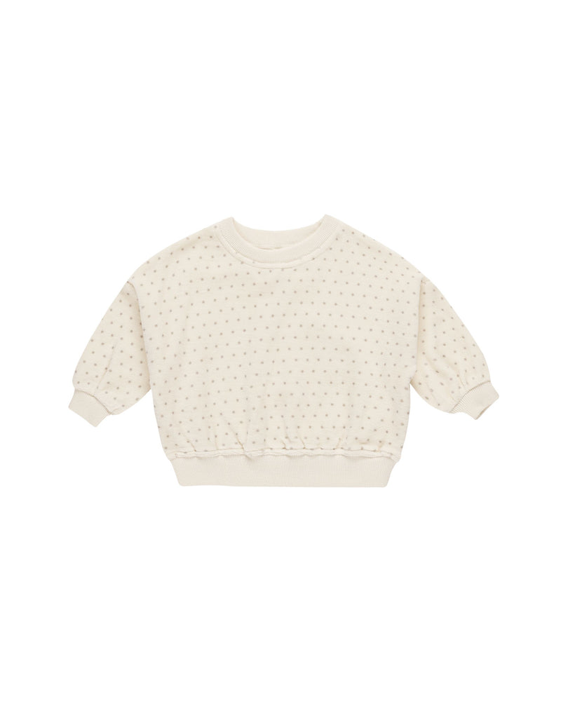 beige velour sweatshirt with gray polka dots on it. 