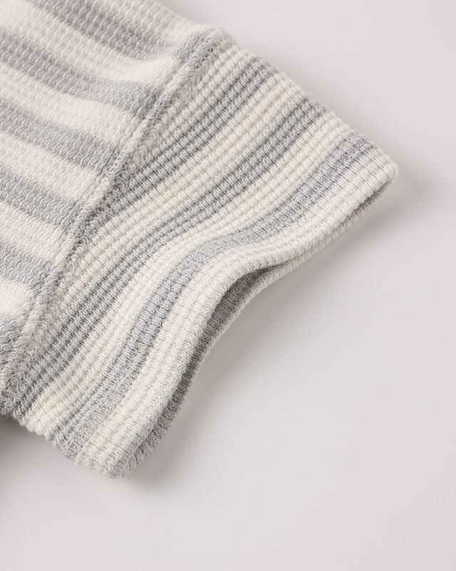 Close-up of gray and white striped socks on a light gray background