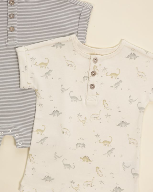 Two baby rompers, one striped and one with dinosaur pattern, on a light background.