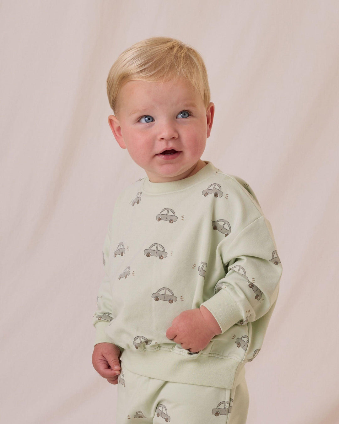close up of the print of the cars and the color of the sweatshirt. This picture shows the child wearing the clothes to be happy and comfortable. 