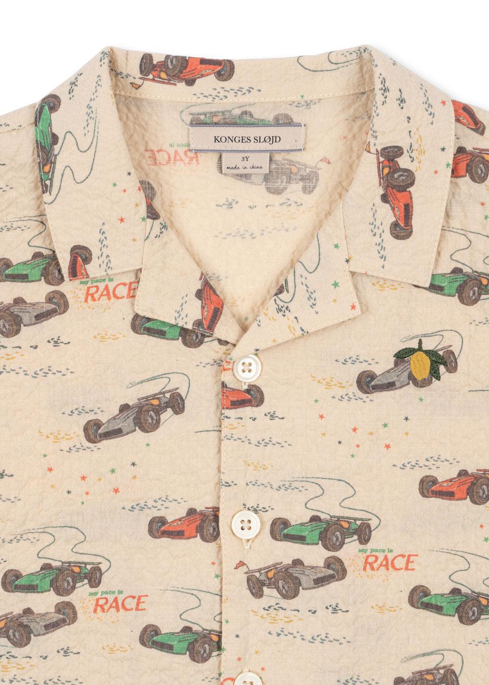 up close picture of the race car print on the shirt. 
