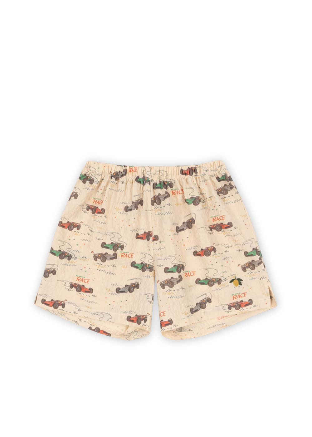 this pictures shows the shorts and race car print all over the shorts . race cars come in red, blue and green. elastic at the waist and notches at the bottom of the shorts. 