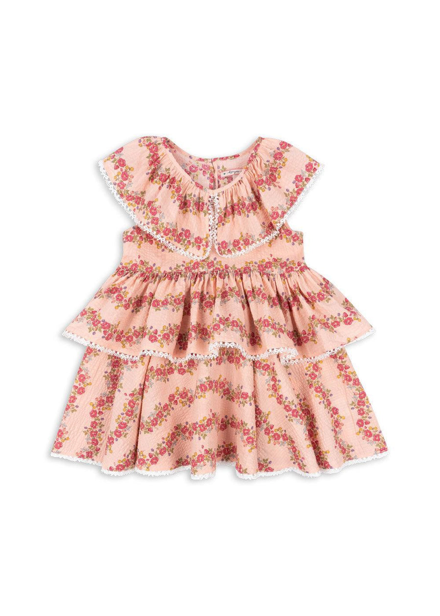Girls dress with two large ruffles and larger collar trimmed in white lace. pink dress with rows of flowers 