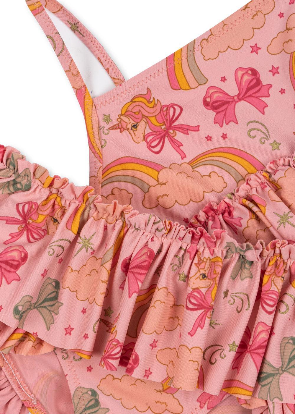 pink bikini swimwear with unicorns, bows and rainbows printed on them. ruffle on top of the bikini bottom and at the bottom of bikini top. 