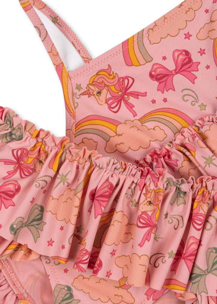 pink bikini swimwear with unicorns, bows and rainbows printed on them. ruffle on top of the bikini bottom and at the bottom of bikini top. 