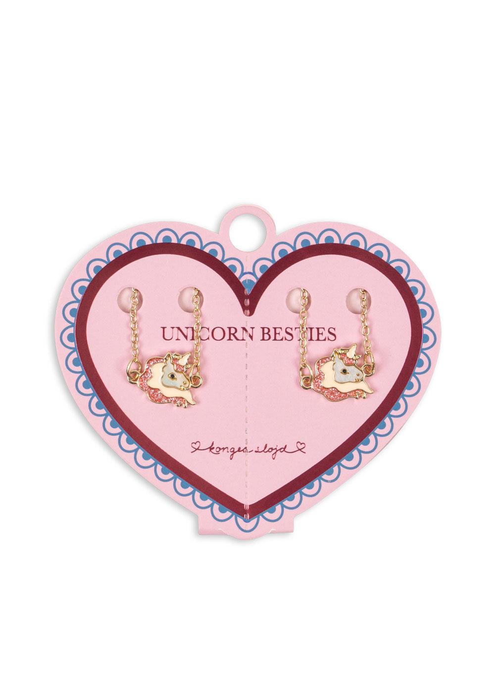 this picture shows the packaging for the unicorn bracelets intact on a pink cardboard heart. 