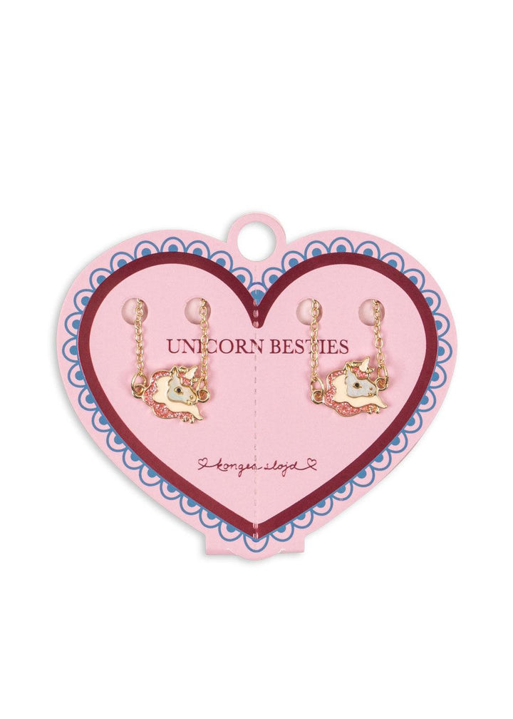 this picture shows the packaging for the unicorn bracelets intact on a pink cardboard heart. 