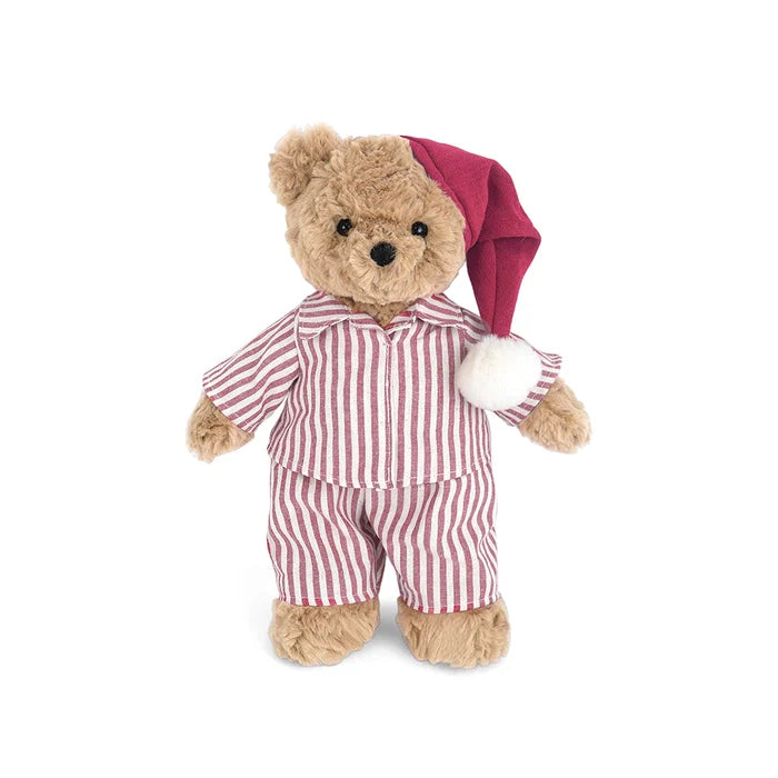 A plush teddy bear wearing red and white vertically striped pajamas and a dark red Santa hat with a white pom-pom, standing against a plain white background.