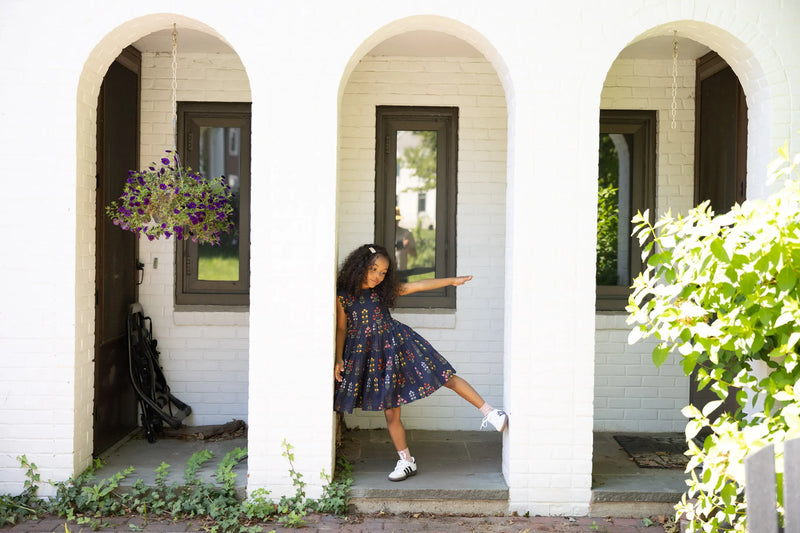 little girl modeling the peachy dress, the way she is standing shows how voluminous the skirt is. 