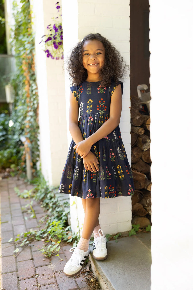 little girl modeling the peachy dress outside. full skirt and fits just right on top. 