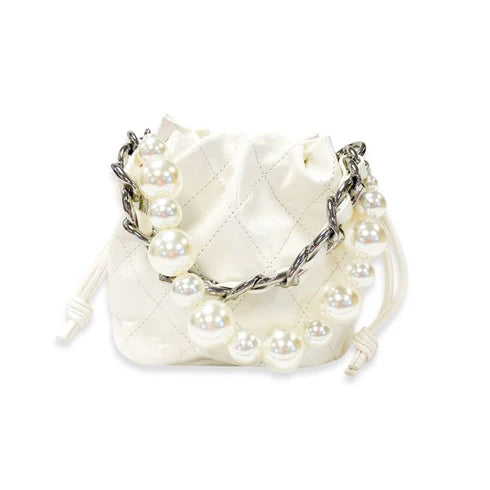 White quilted handbag with pearl embellishments on a white background
