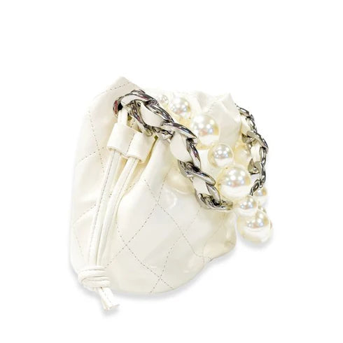 White drawstring pouch with pearl embellishments on a white background