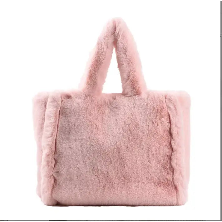 A light pink faux fur tote bag with matching fluffy shoulder straps, shown against a plain white background.
