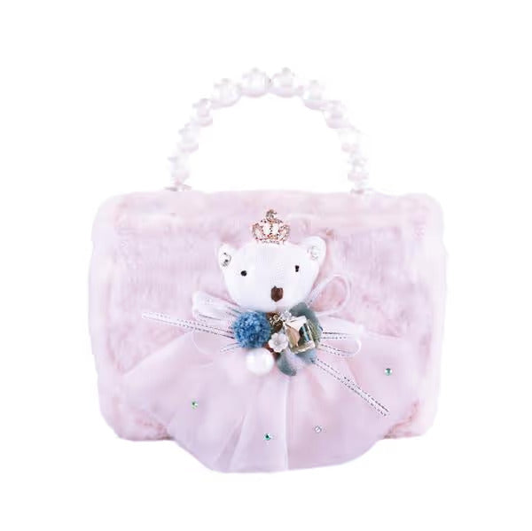 A light pink plush handbag with a pearl-bead top handle, featuring a white teddy bear decoration with a small gold crown, blue and green pom-poms, and a tulle skirt embellished with rhinestones.