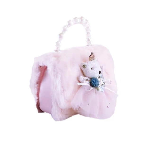 A light pink plush handbag with a fluffy faux-fur body, a tulle skirt, a small white teddy bear decoration with a gold crown, and a pearl-beaded top handle, shown on a plain white background.