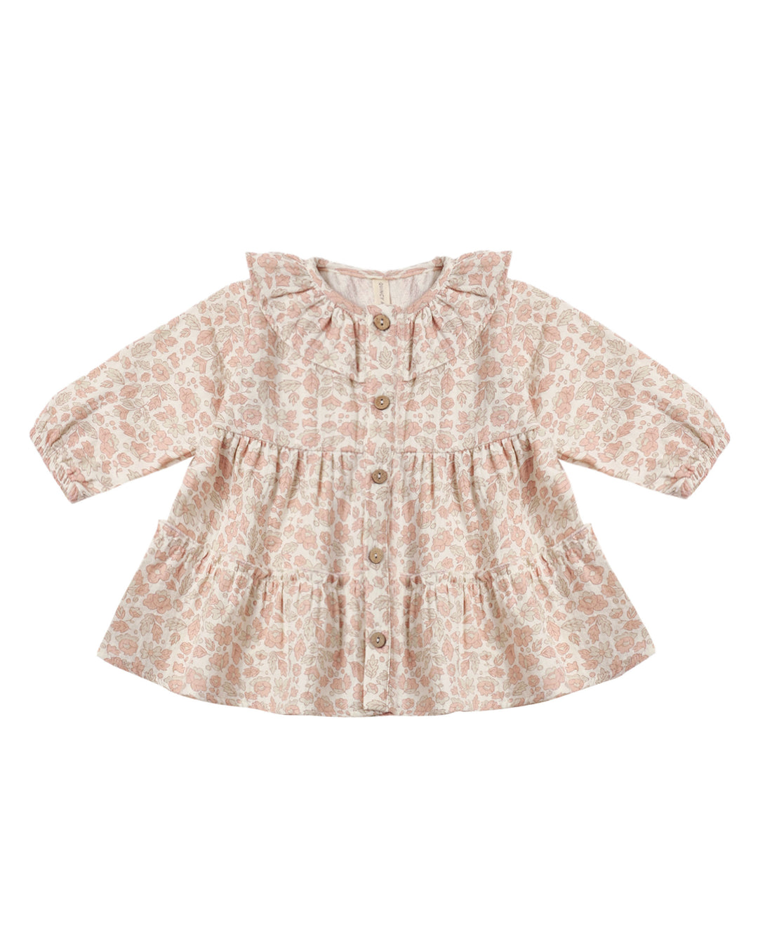 A long-sleeve baby girl's peplum blouse with a tiered skirt and button-front closure, featuring a light beige and dusty pink floral pattern.
