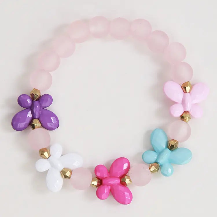 Colorful butterfly-themed bracelet with pink, purple, blue, and white beads on a light background